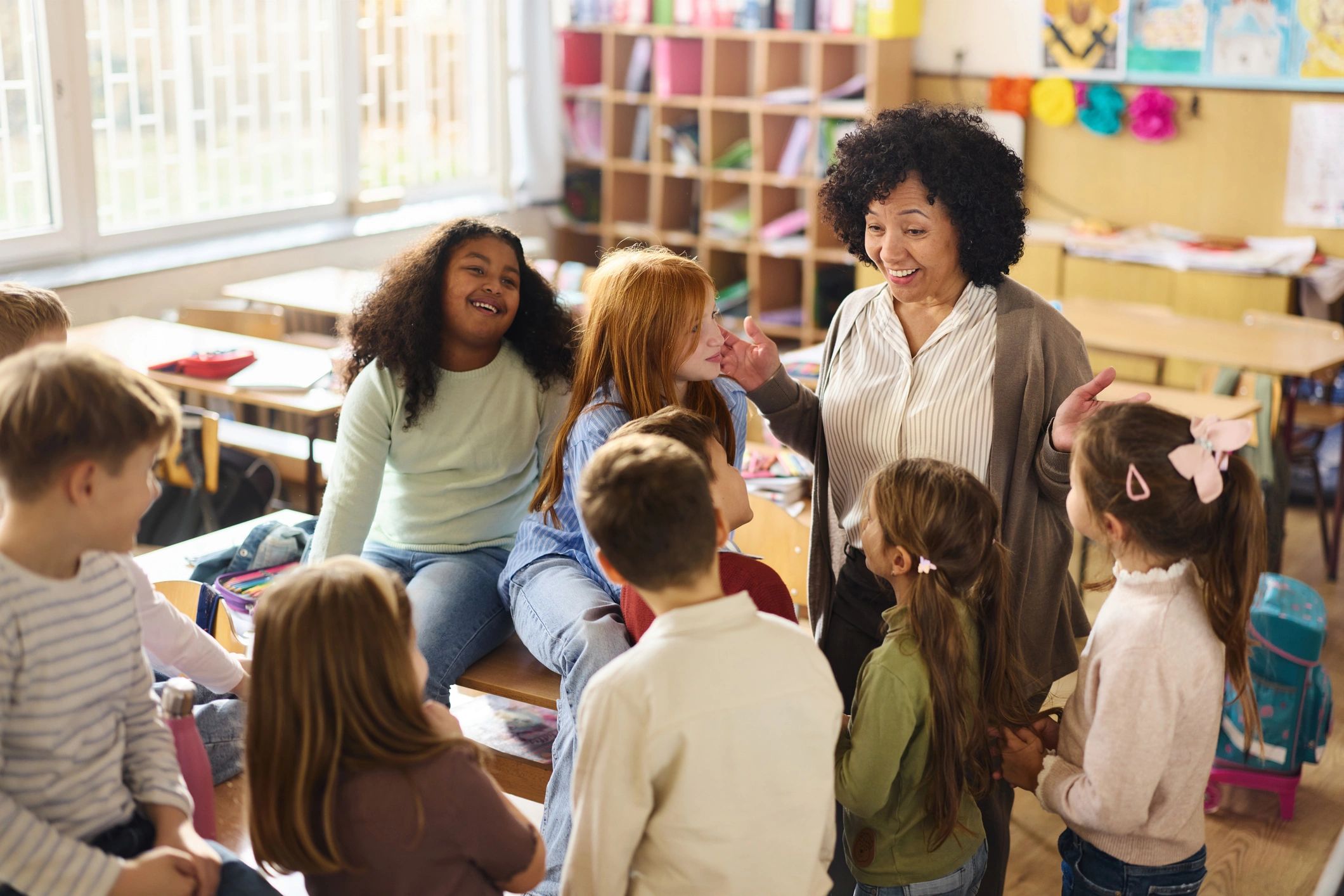 Teacher supporting elementary students in the classroom